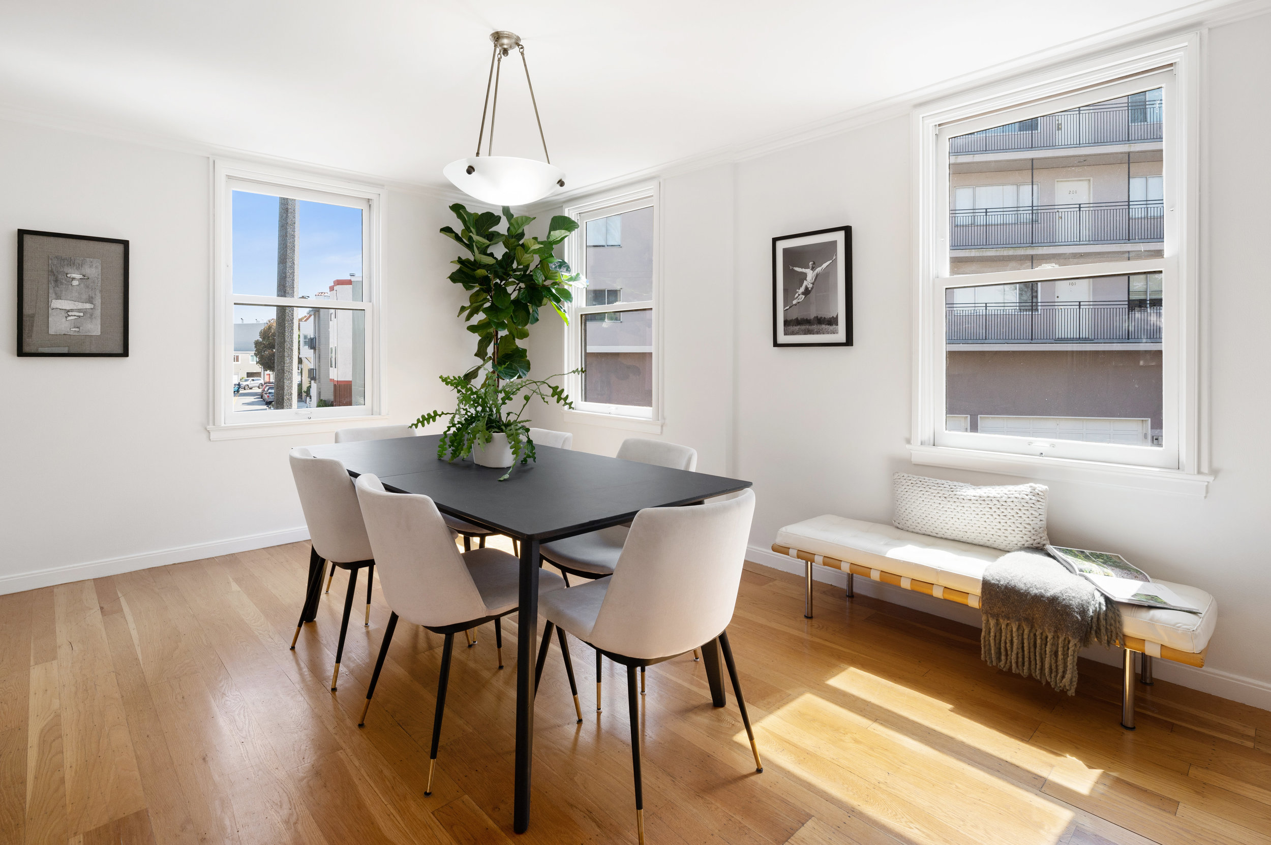 Property Photo: View of the dining room featuring wood floors and three large windows