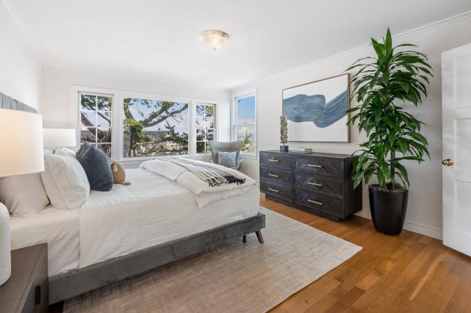 Property Thumbnail: Primary bedroom with large windows and wood floors