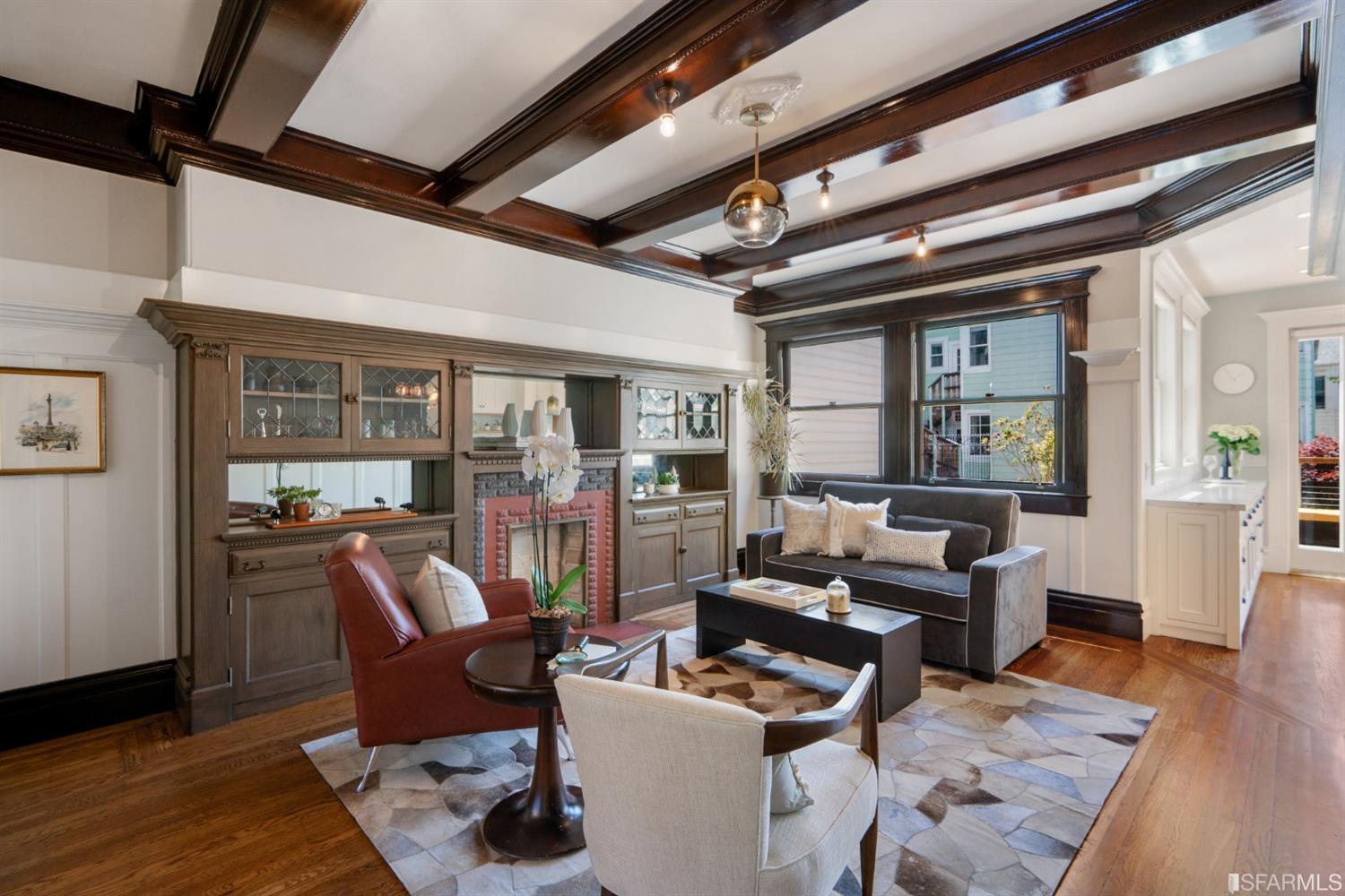 Property Photo: Living area with wood beamed ceilings and fireplace 