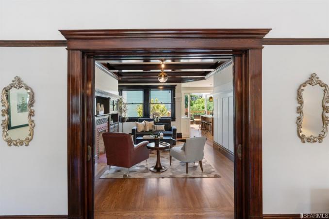Property Thumbnail: View of the living area as seen through a beautiful wood-framed door-way