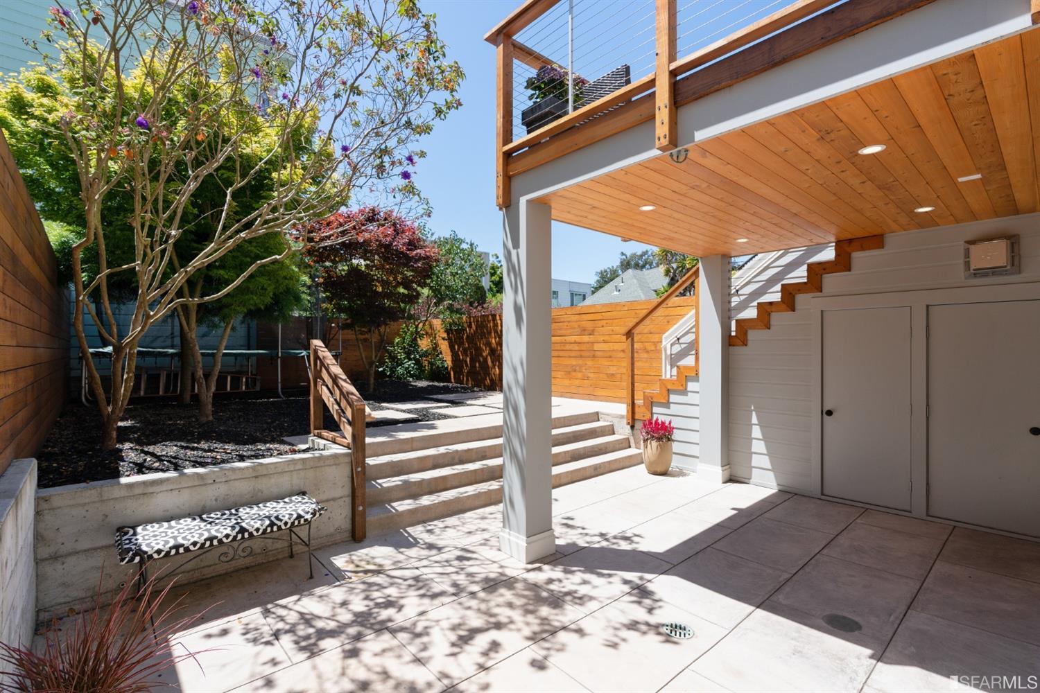 Property Photo: A sunny view of the outdoor patio and yard