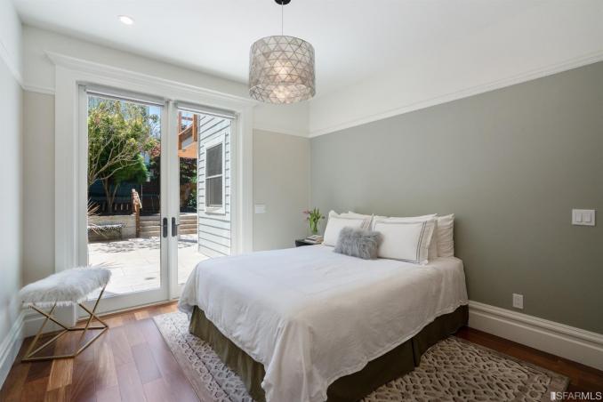 Property Thumbnail: Lower bedroom with doors leading to the private yard