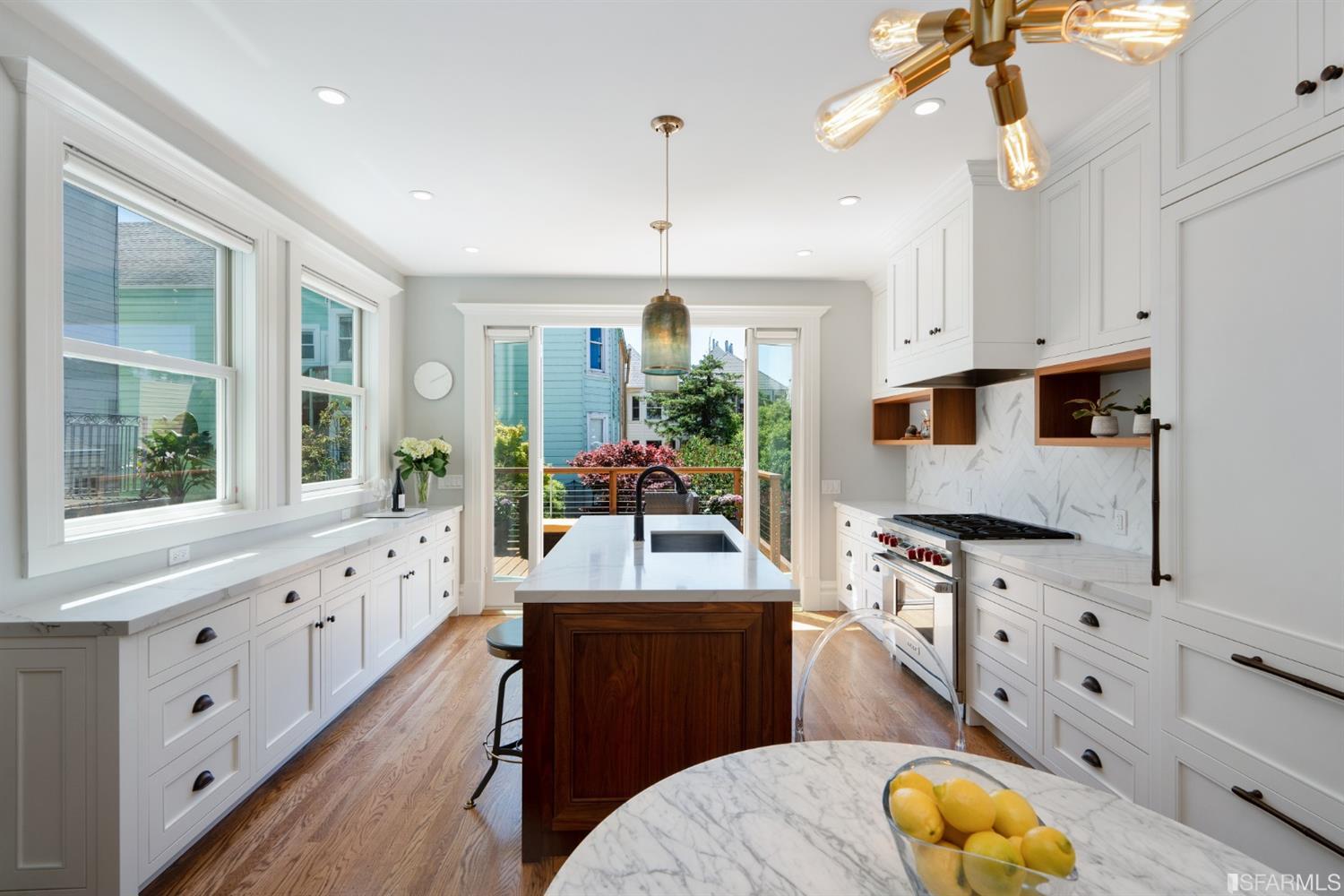 Property Photo: Kitchen, featuring white cabinetry and modern light fixtures