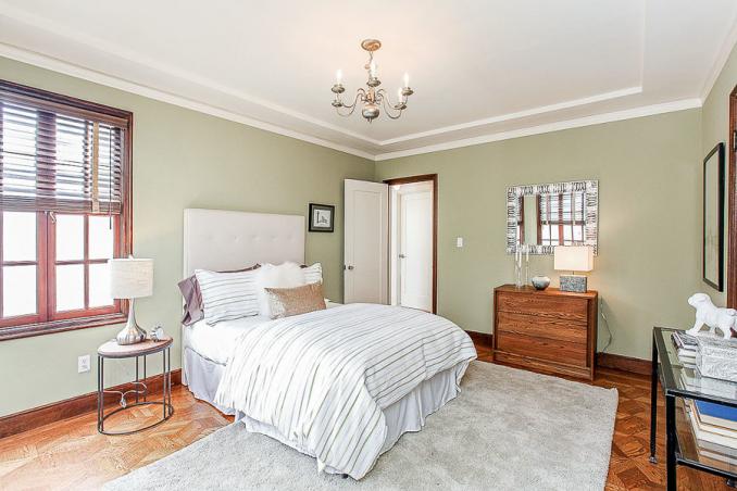 Property Thumbnail: View of a large bedroom with crown moulding and wood floor
