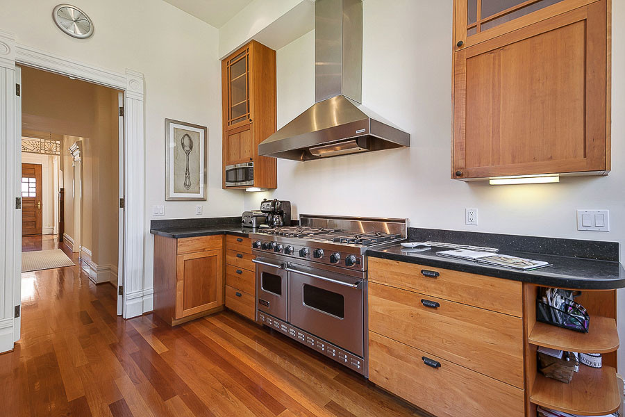 Property Photo: View of the kitchen, showing high-end appliances and wood cabinets