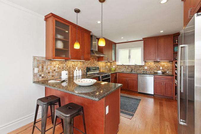 Property Thumbnail: View of the kitchen, featuring wood cabinets and floors