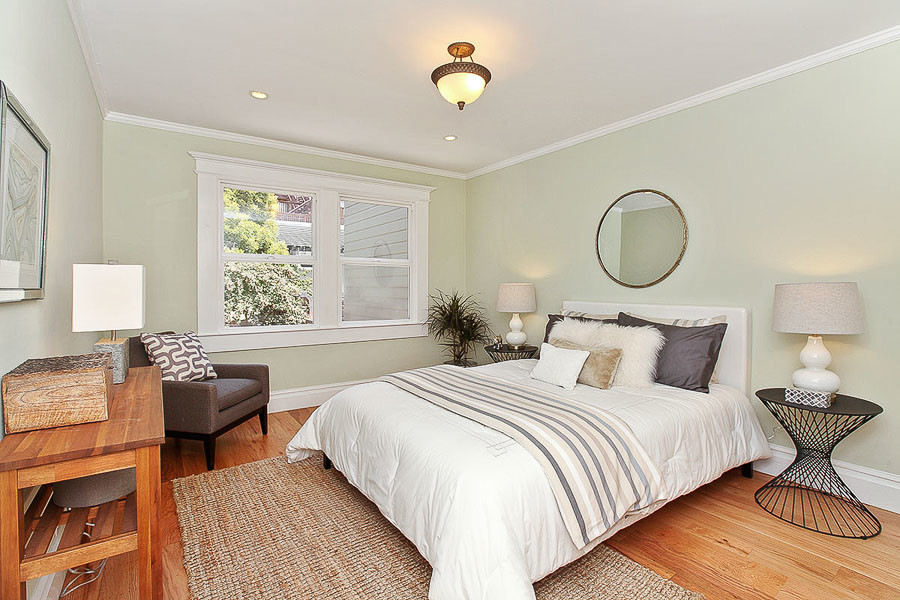 Property Photo: View of a bedroom, featuring large windows and wood floors