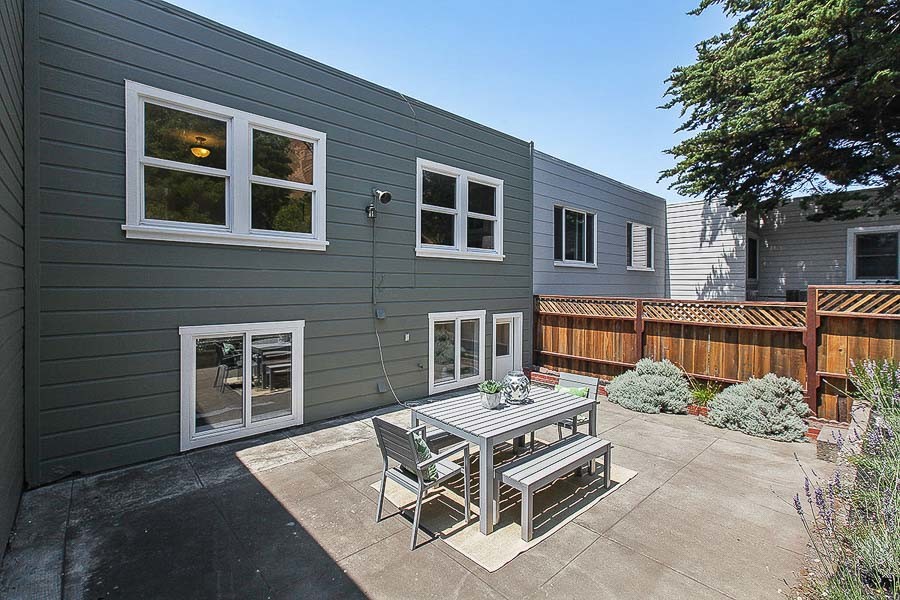 Property Photo: Rear exterior view of 1734 18th Avenue, showing an outdoor dining area