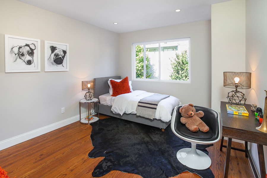 Property Photo: Bedroom with wood floors and large window