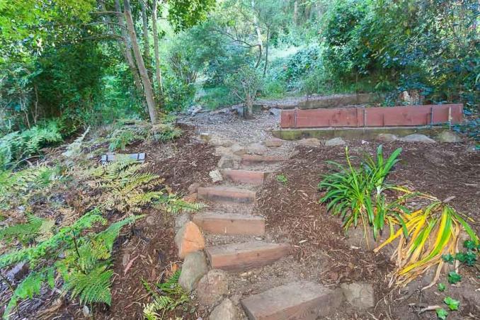 Property Thumbnail: View of a trail with descending steps and various plants