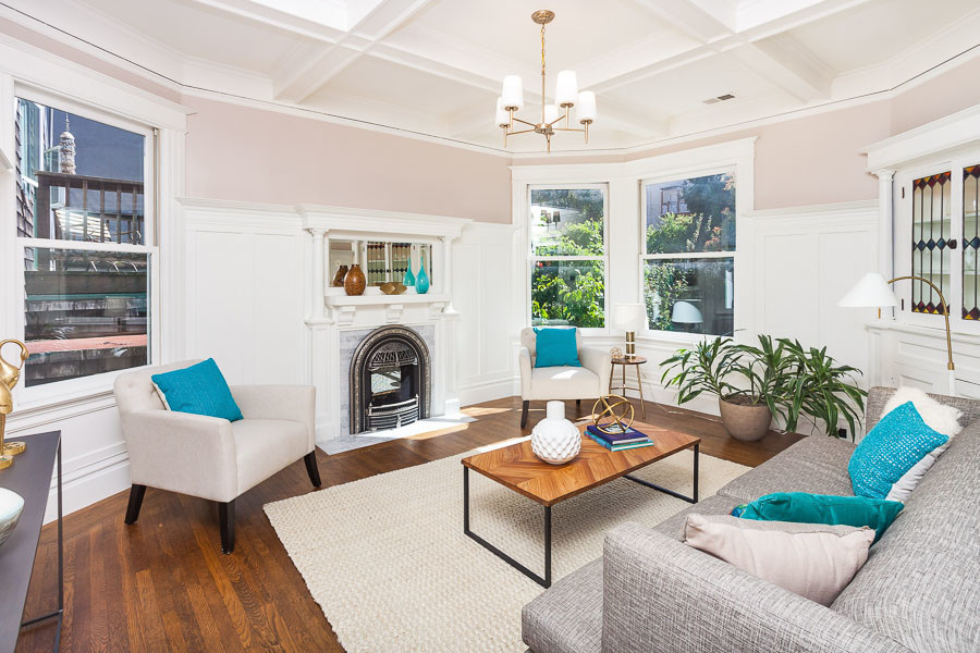 Property Photo: View of the living room, featuring a white boxed ceiling and a fireplace