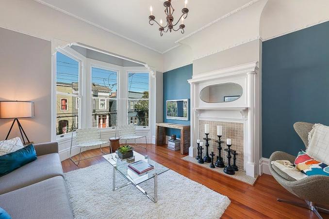 Property Thumbnail: Living room with fireplace mantle and three large windows