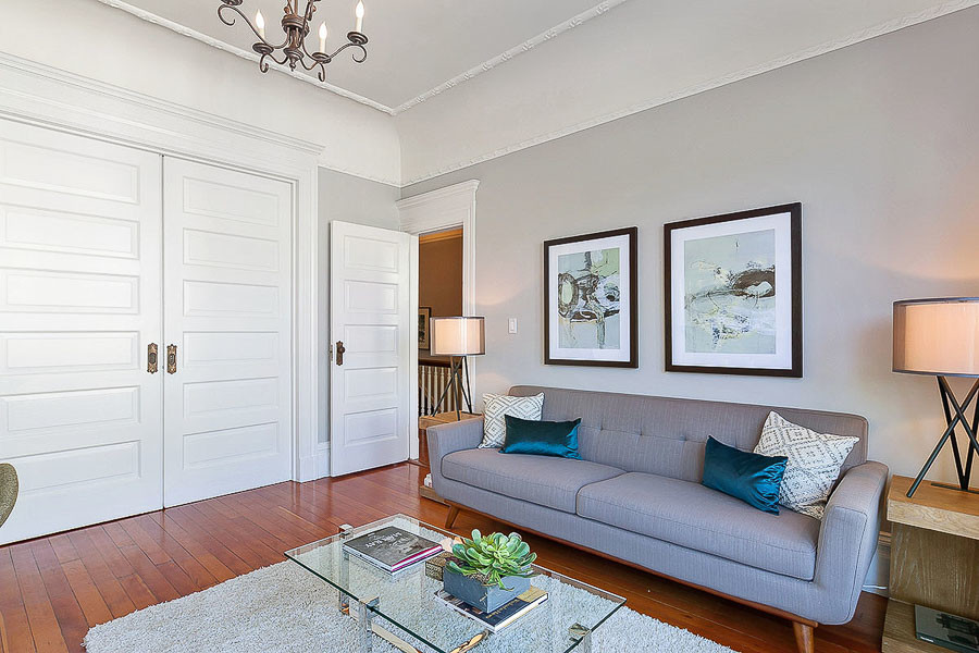 Property Photo: View of the living room, featuring crown moulding and wood floors