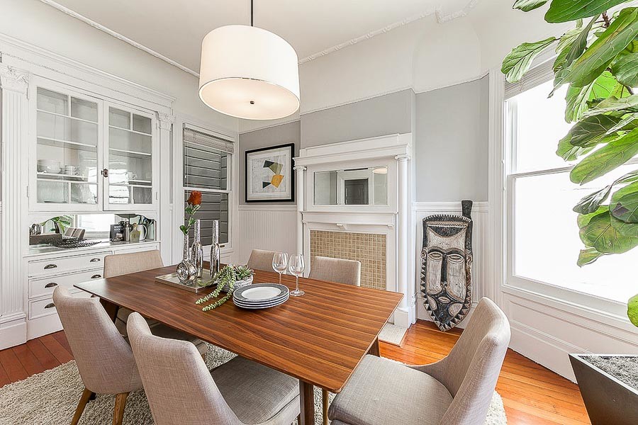 Property Photo: View of the dining room, featuring a large window and fireplace mantel