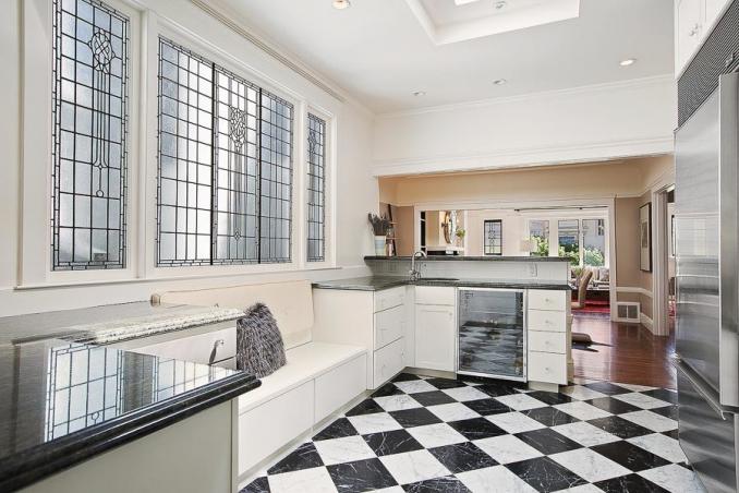 Property Thumbnail: View of the kitchen, featuring black and white tiled floor and large stained glass windows