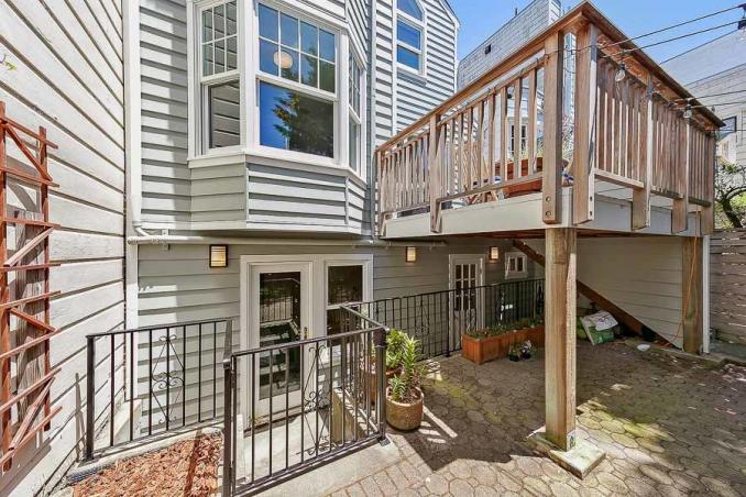 Property Thumbnail: Rear view of 511 15th Avenue, showing walk-out doors and an upper deck