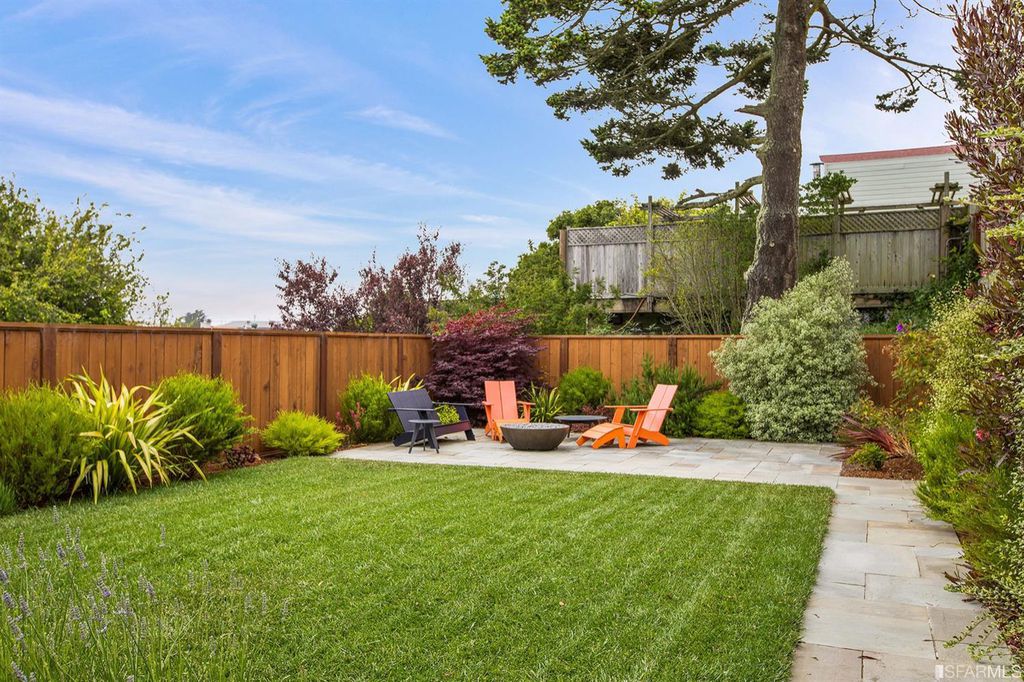 Property Photo: View of the lush lawn, featuring a large grassy area and out door living space