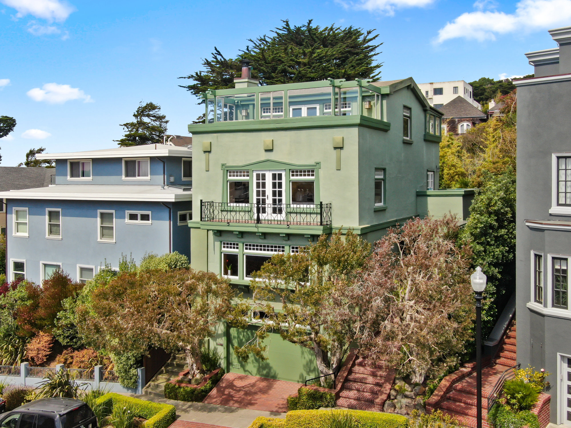 Front exterior view of 4 Ashbury Terrace, showing a three story Craftsman style home in Ashbury Heights, presented by John DiDomenico