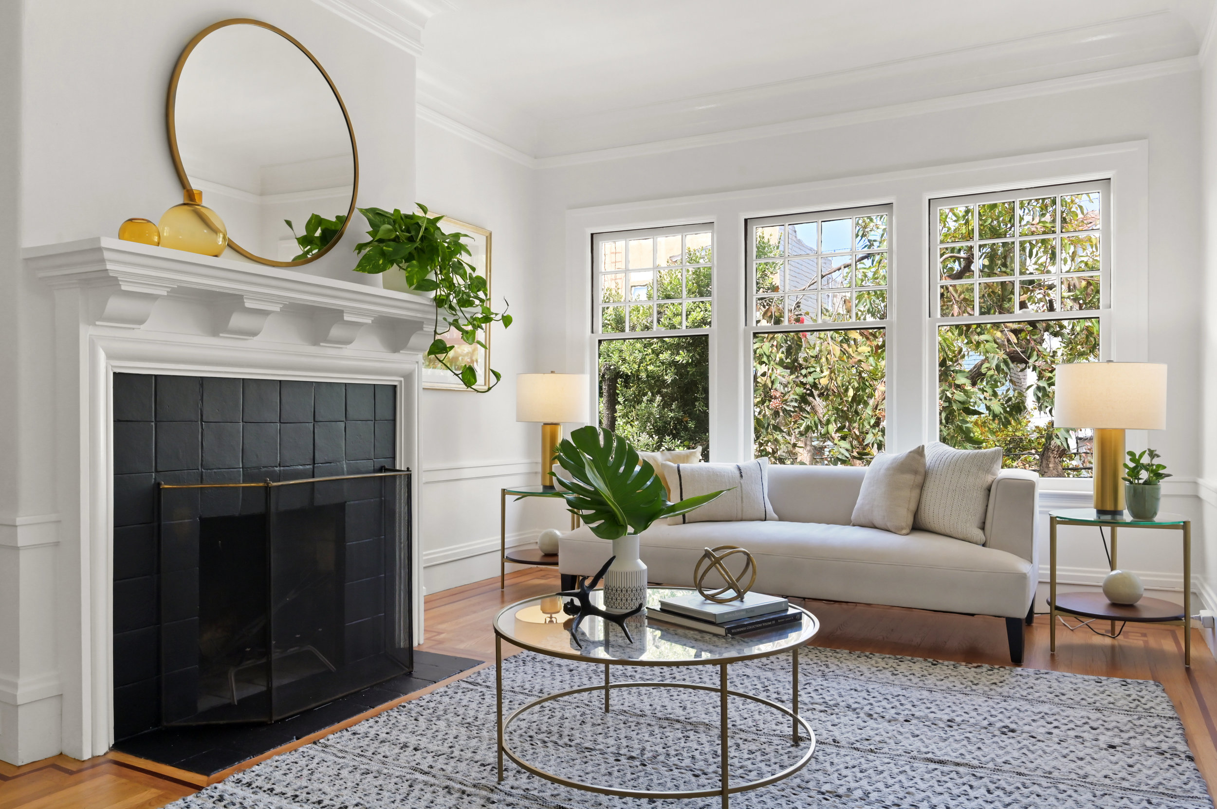 Close-up of the living room showing the fireplace and three large windows