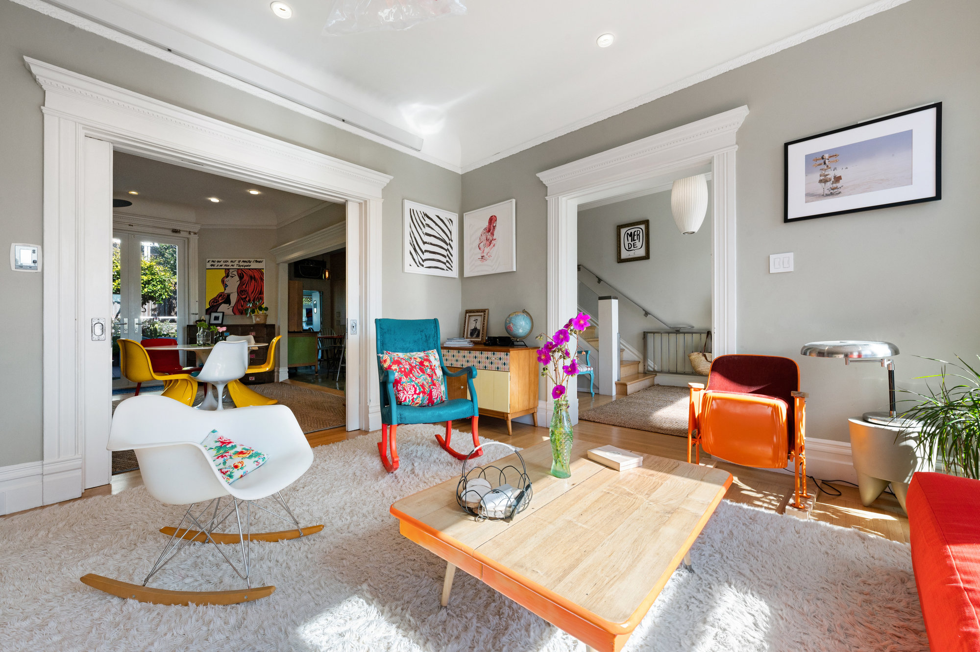 View of the living room, showing magnificent wood trim surrounding the entry