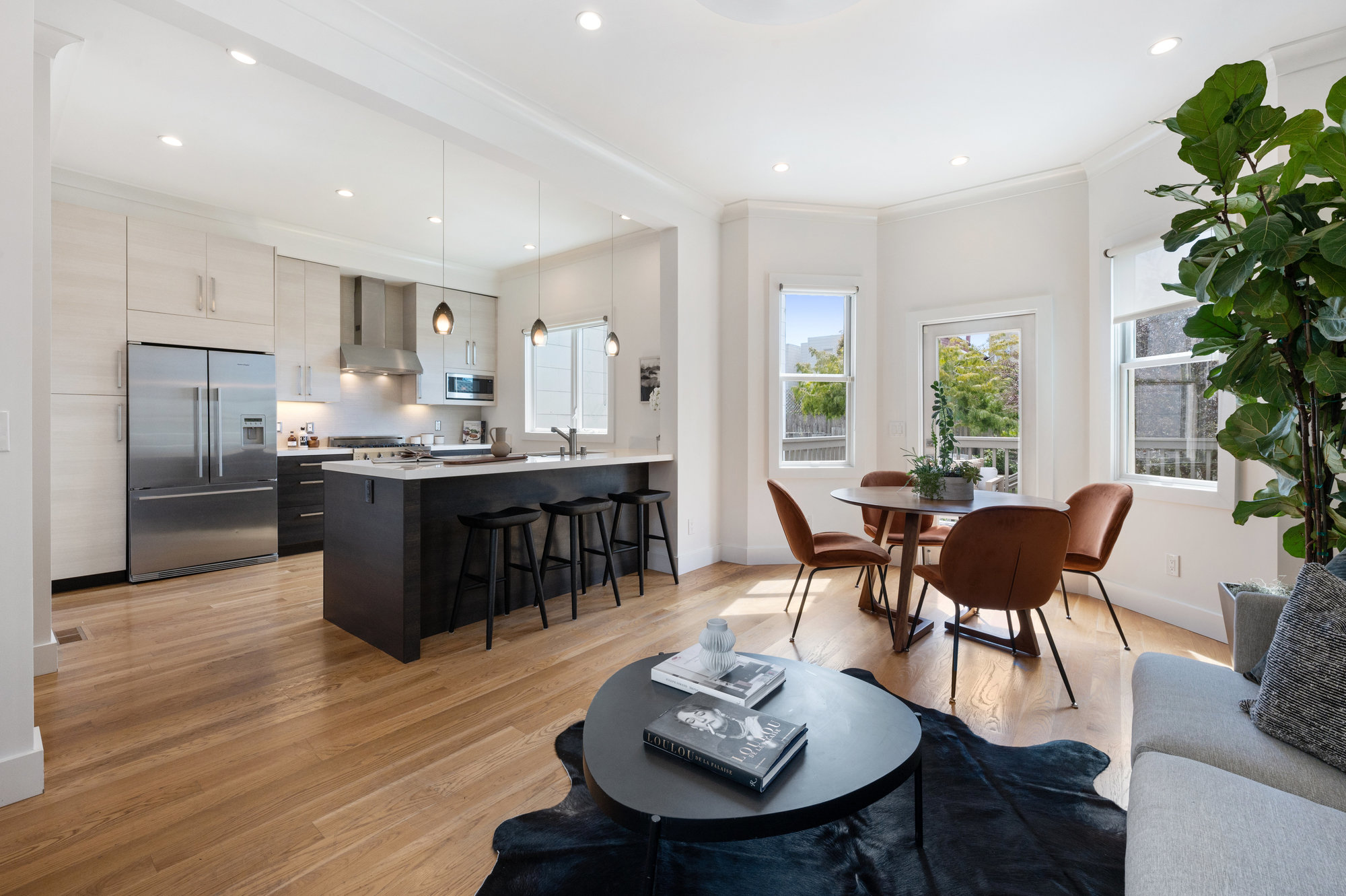 Side-view of the open floor plan, showing kitchen, dining, and living room