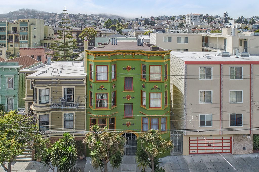 Front exterior view of 464 Bartlett, featuring a multi-story property with green facade