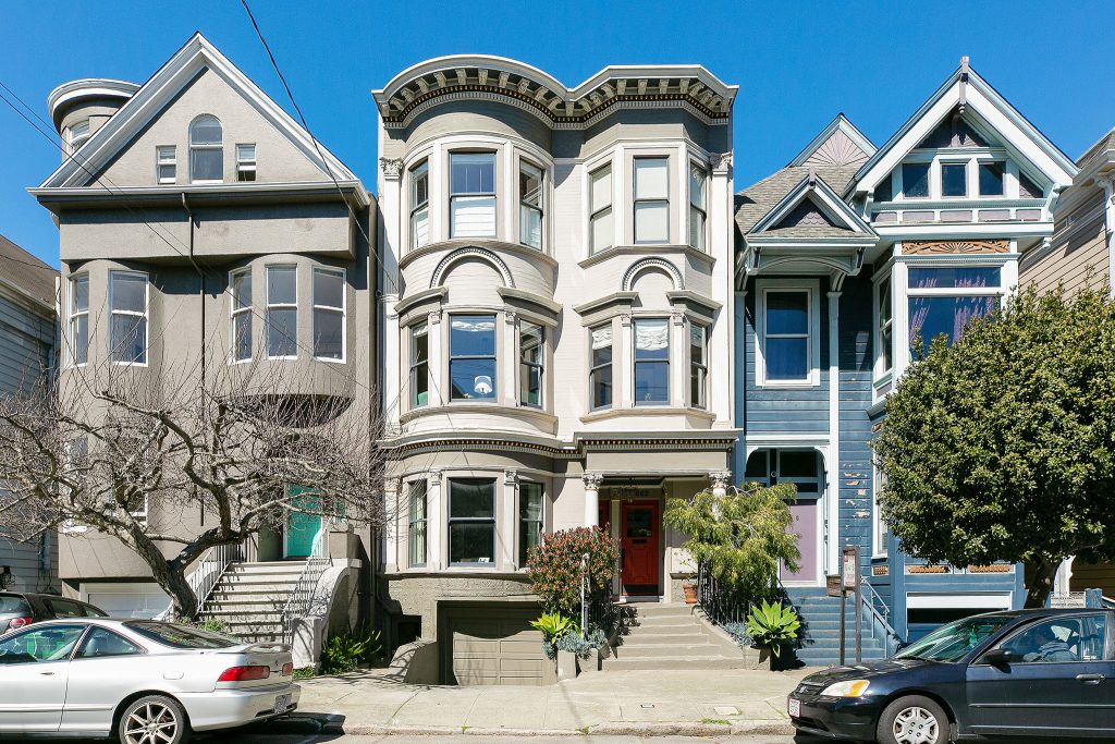 Front exterior of 1664 Page Street, showing a home with light tan facade