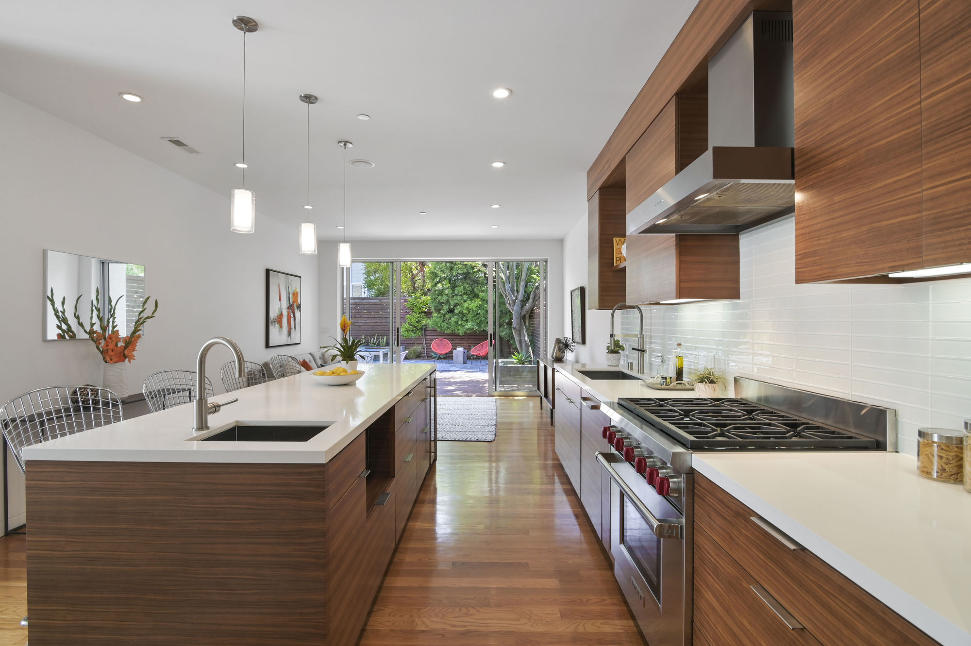 01016 View of the lower unit kitchen, featuring wood floors and an island