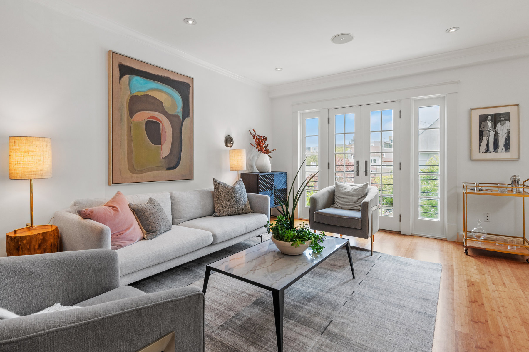 Closer up of living room space. Beautiful french doors that open up to Cole Street. Lots of natural light.