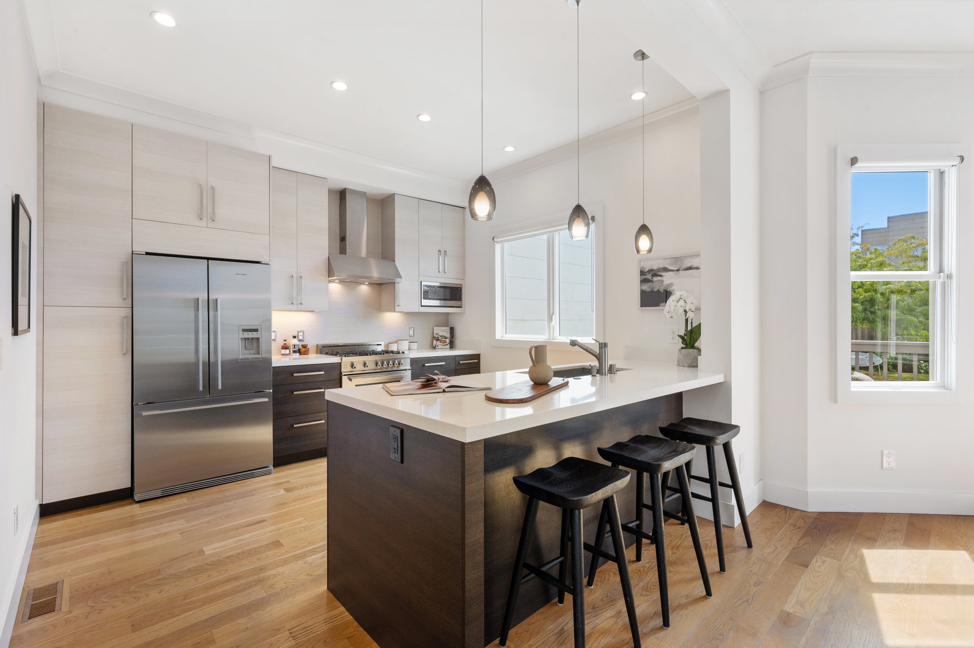 Kitchen island and cooking area, featuring wood floors