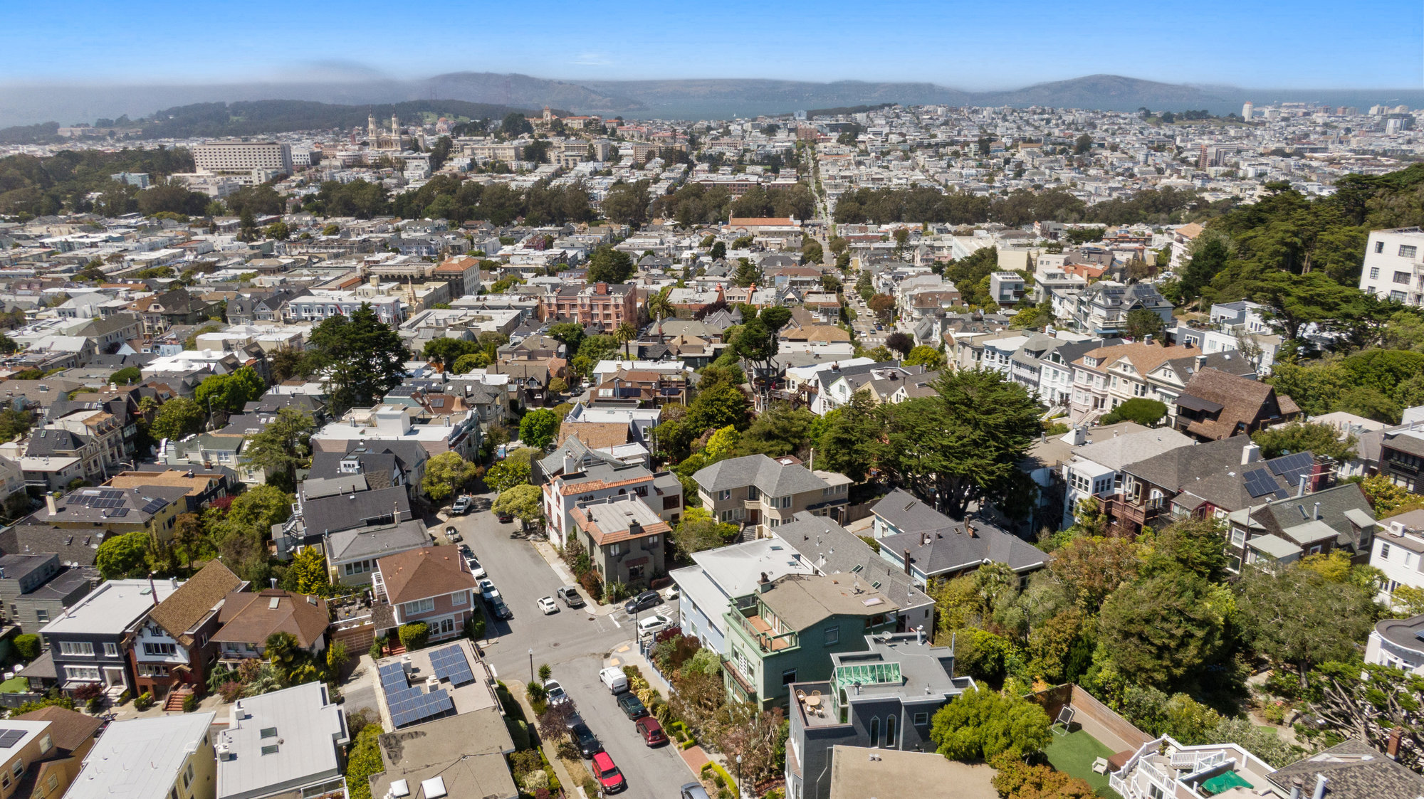Aerial view of 4 Ashbury Terrace and downtown San Francisco beyond
