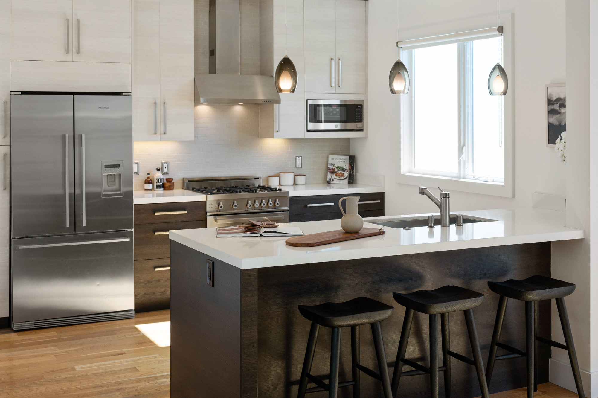 Close-up of the kitchen island with dark cabinets and white counters