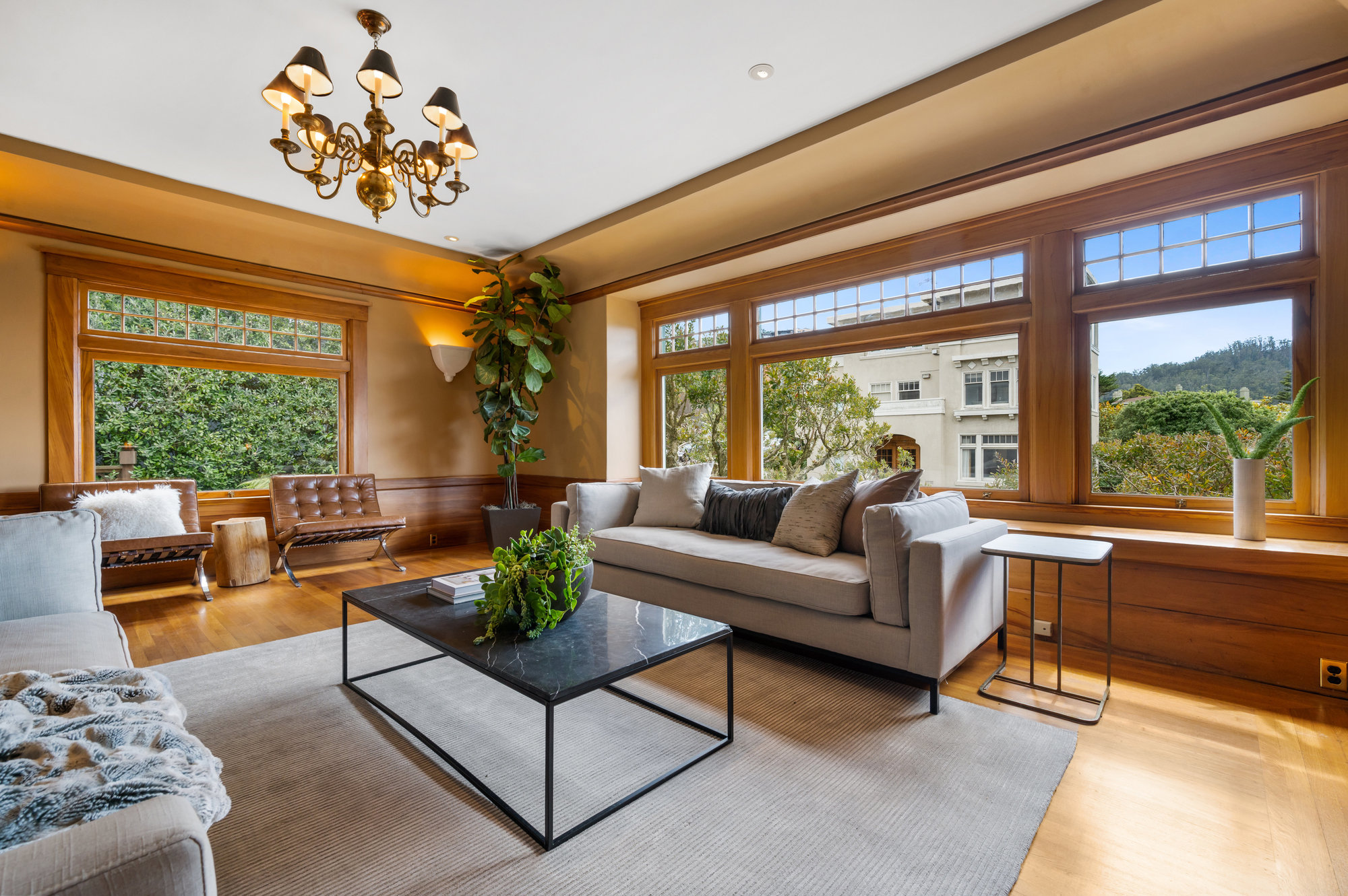 Formal living room with large windows and wide wood frames