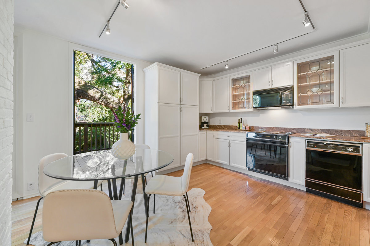 016025 Dining area and kitchen, featuring white cabinets