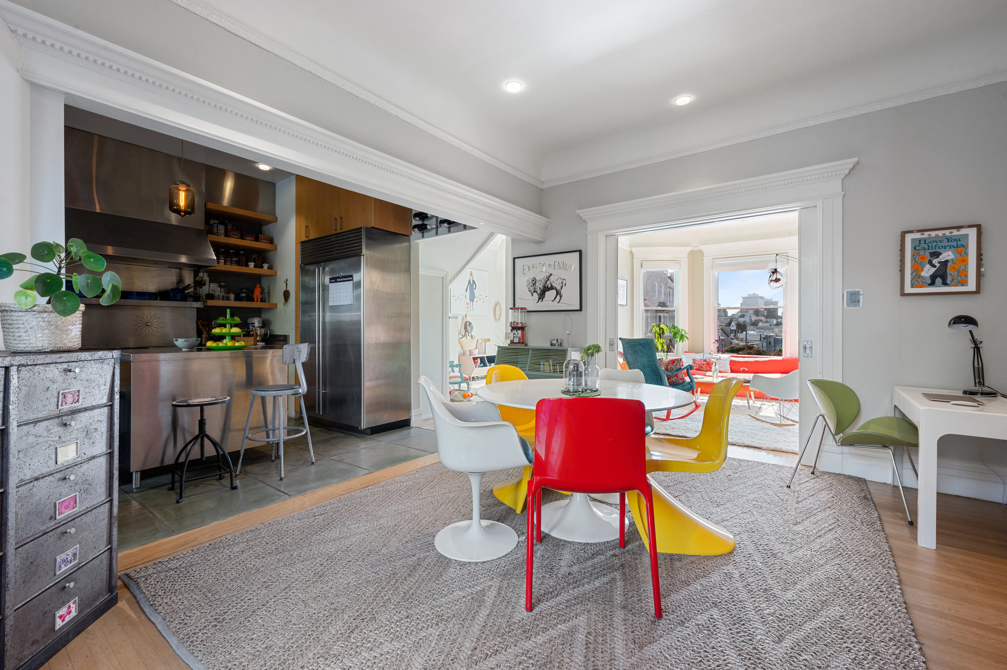 Formal dining room with a partial view into the adjacent living room and kitchen