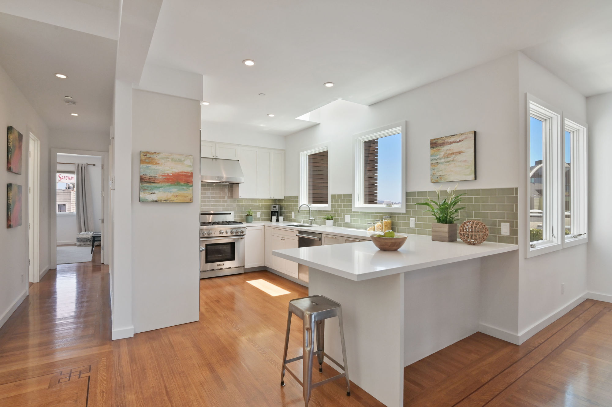 01728 Kitchen, with lots of natural light, wood floors, and light green tile backsplash