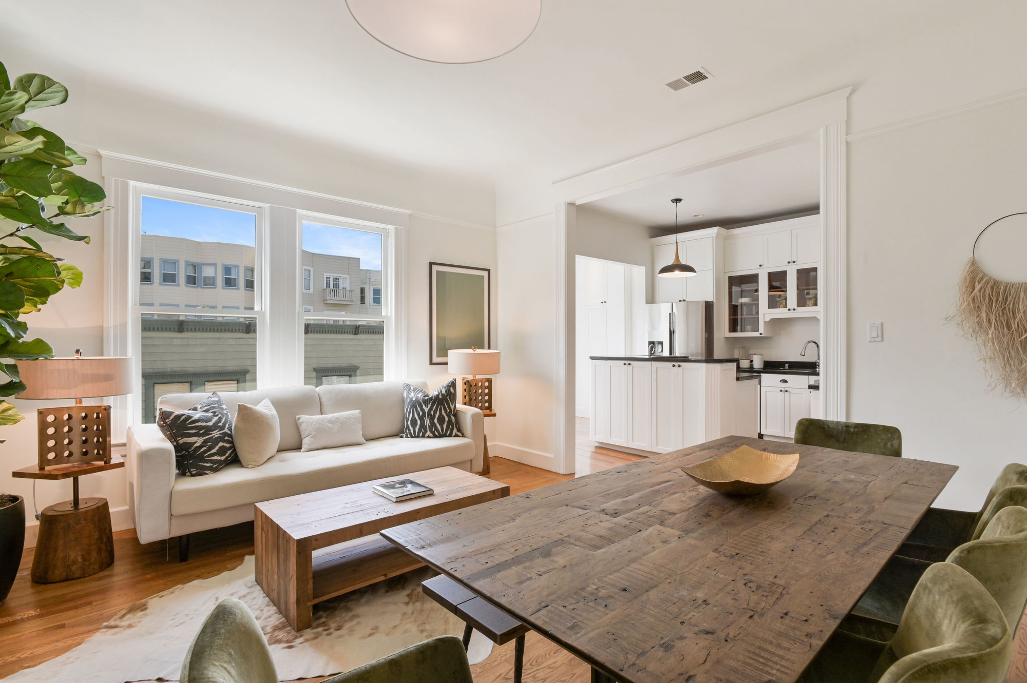 View of a secondary living area adjoining the kitchen, this space features wood floors and natural light