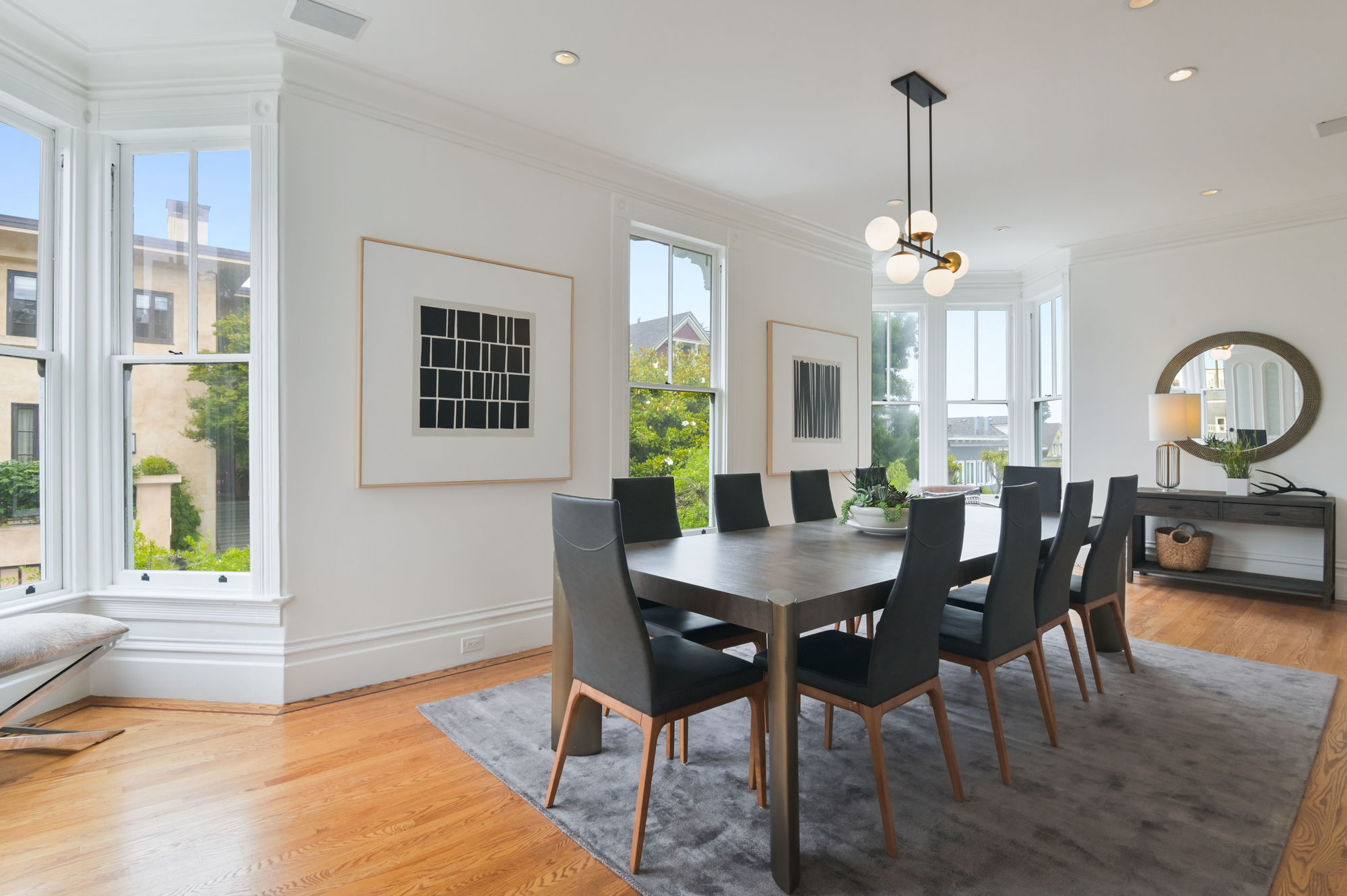 View of a formal dining room with wood floors and plenty of natural light