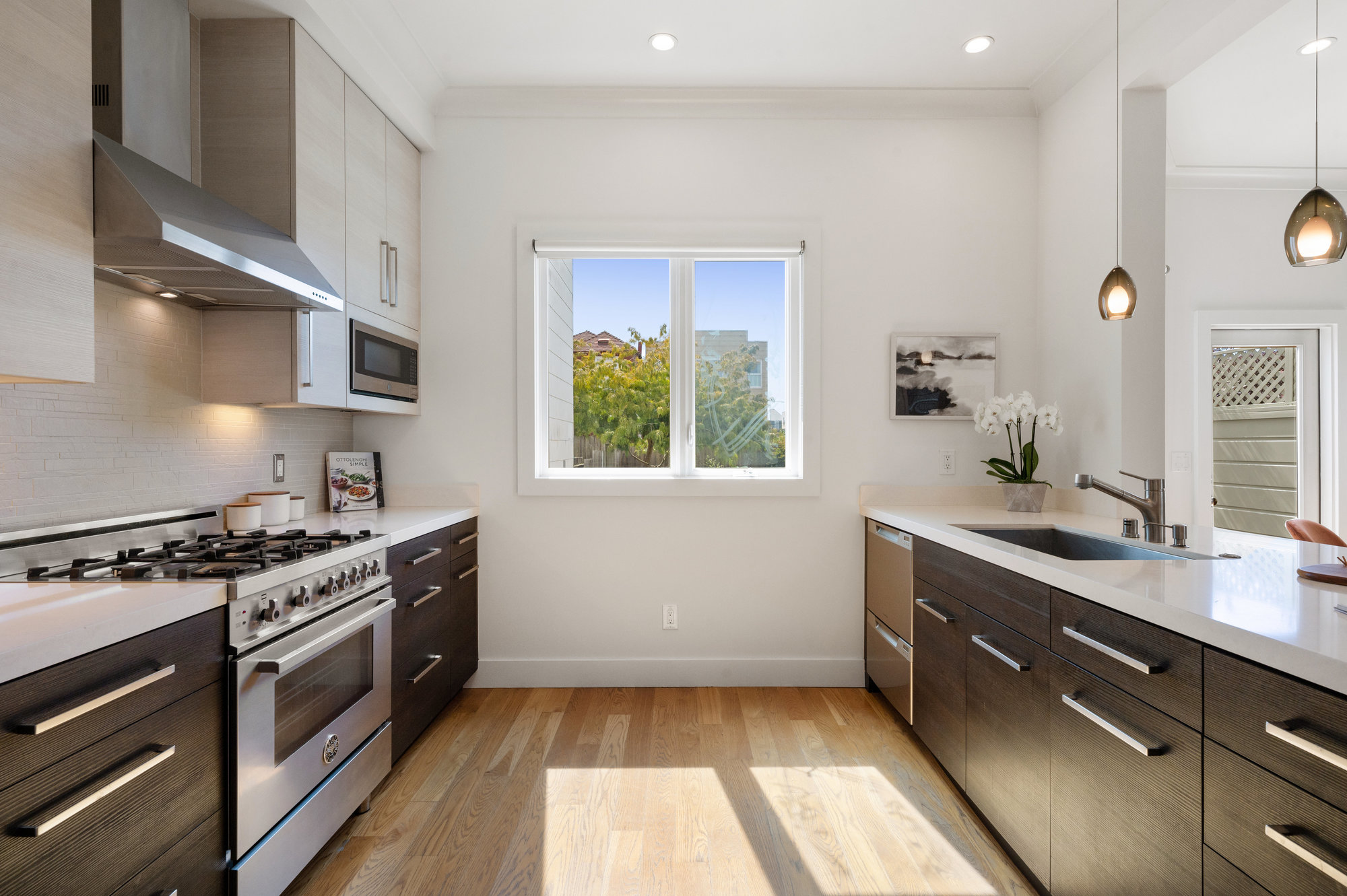 Kitchen, showing the stove and cabinetry on left and island on the right