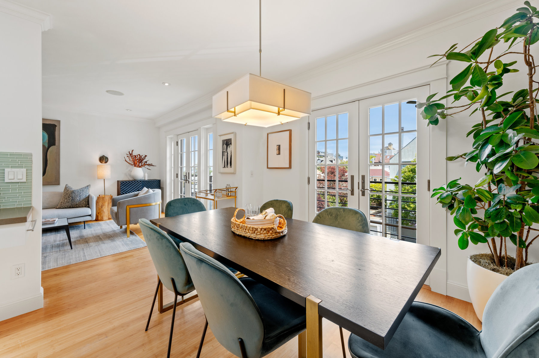 Dining table with living room in back corner. Beautiful hardwood floors.