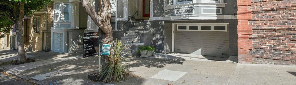 View of a for sale sign outside of a home