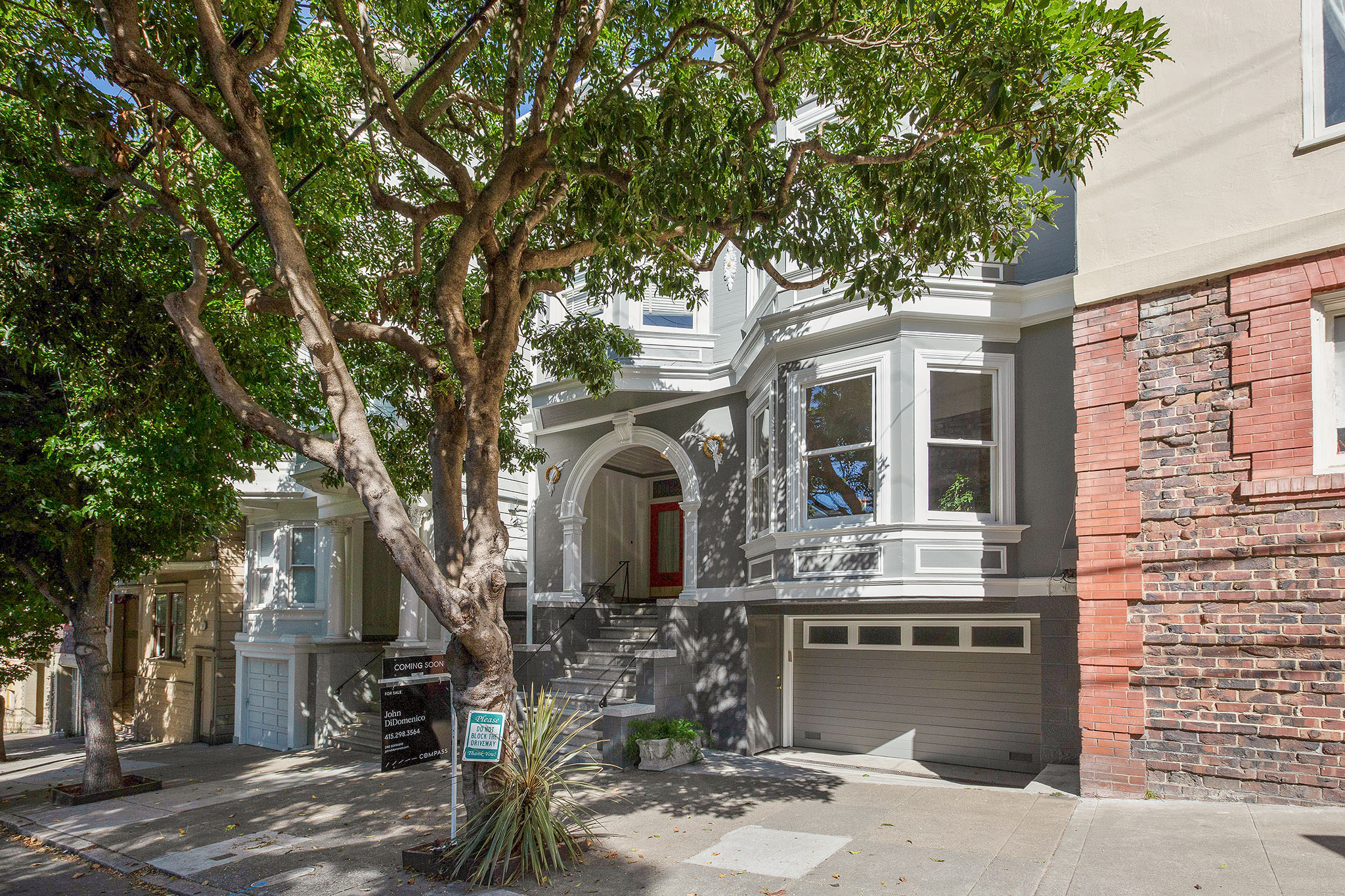 Exterior view of 1242 Cole Street, featuring a tree lined street