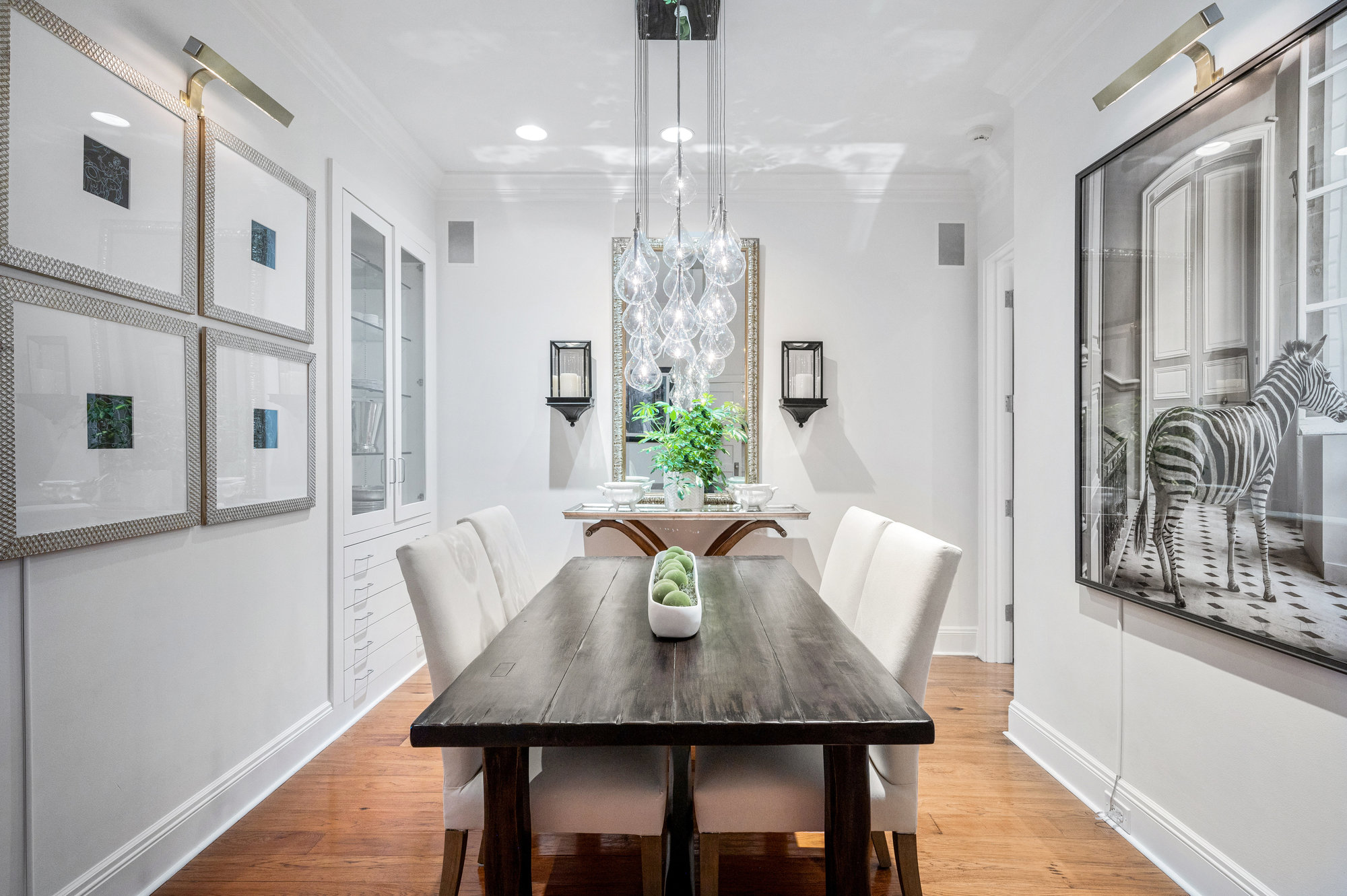 View of the dining room, showing a glass chandelier and wood floors