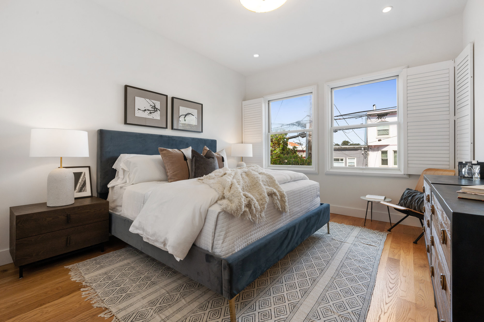 View of a bedroom with two large windows