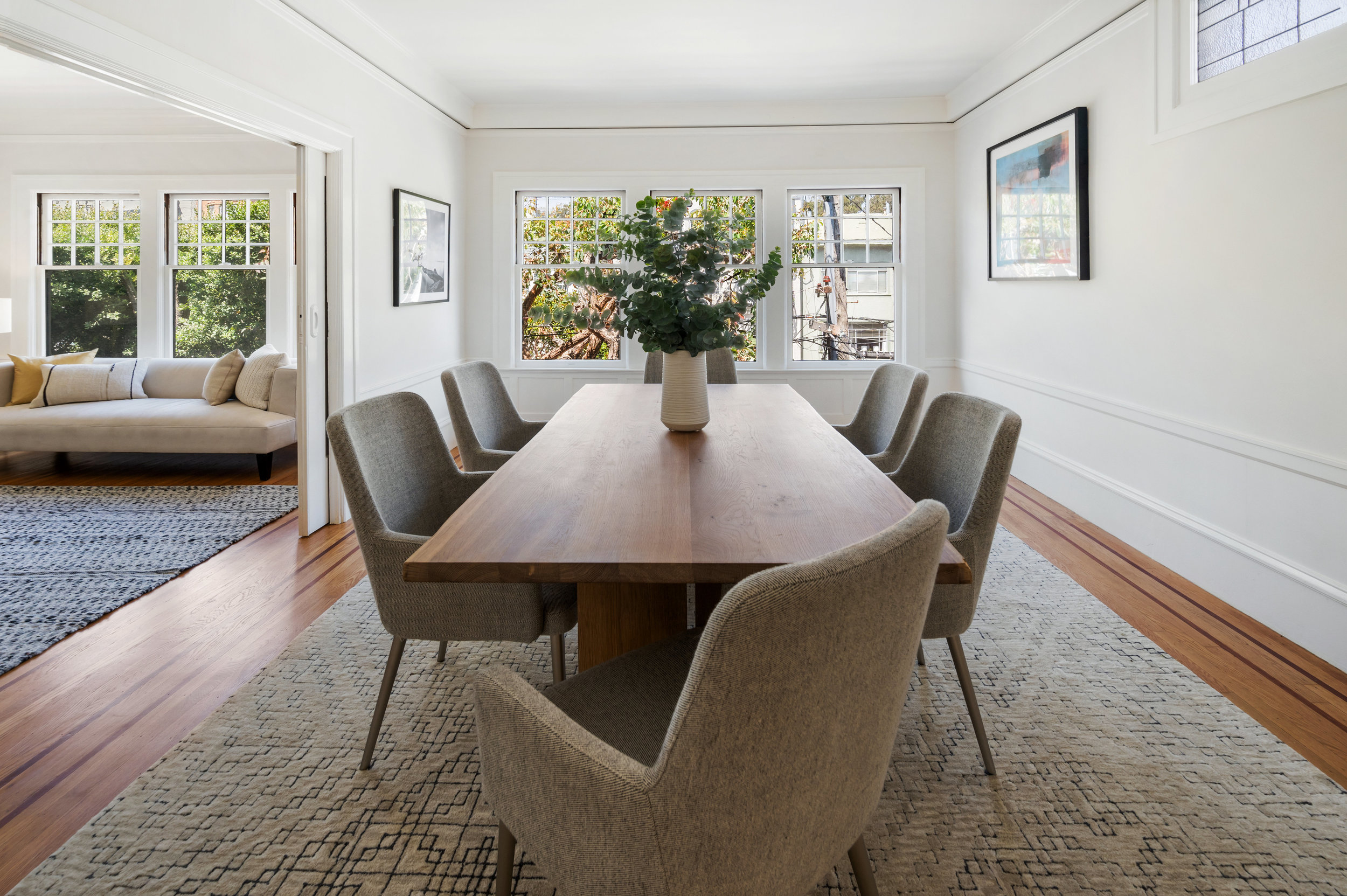 Dining room, featuring three large windows at one end