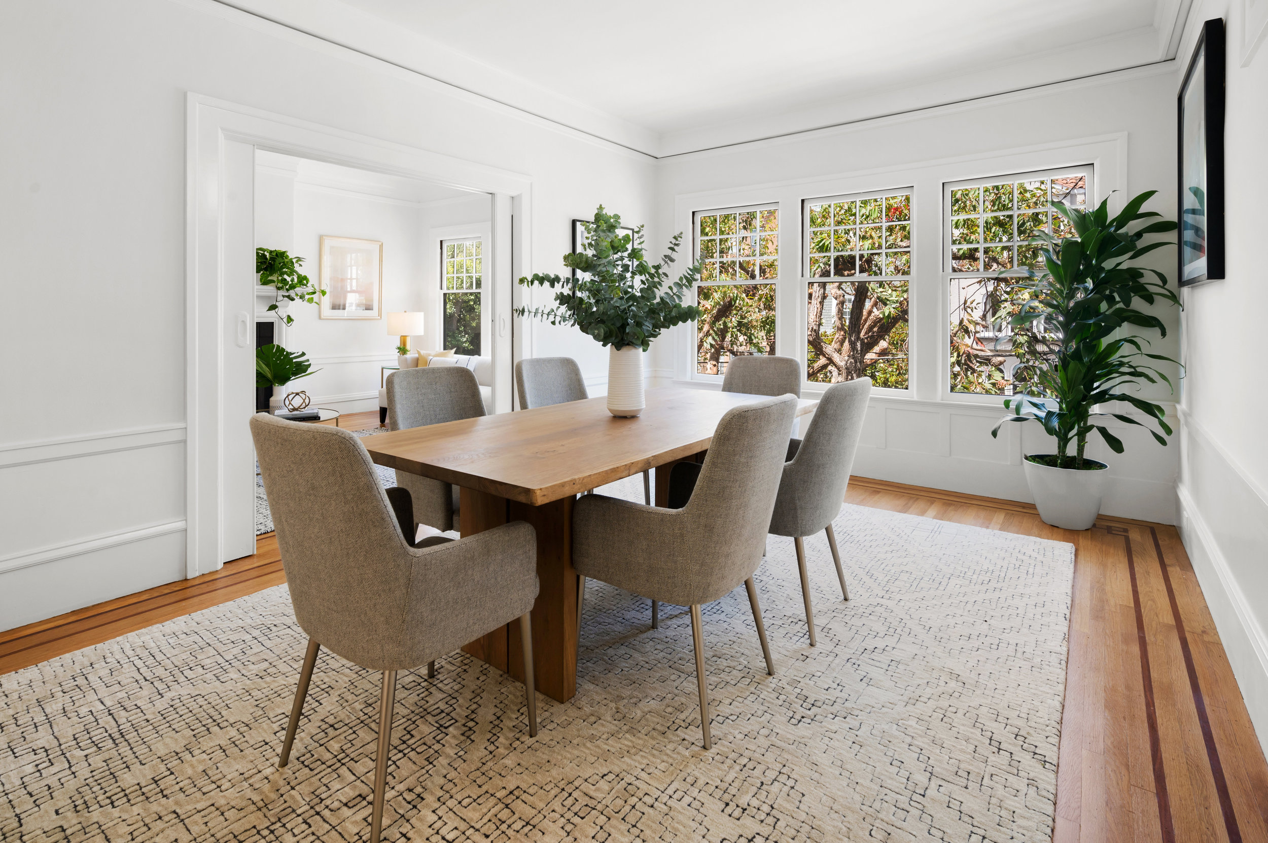 Side-view of the dining room, featuring crown moulding and wood floors