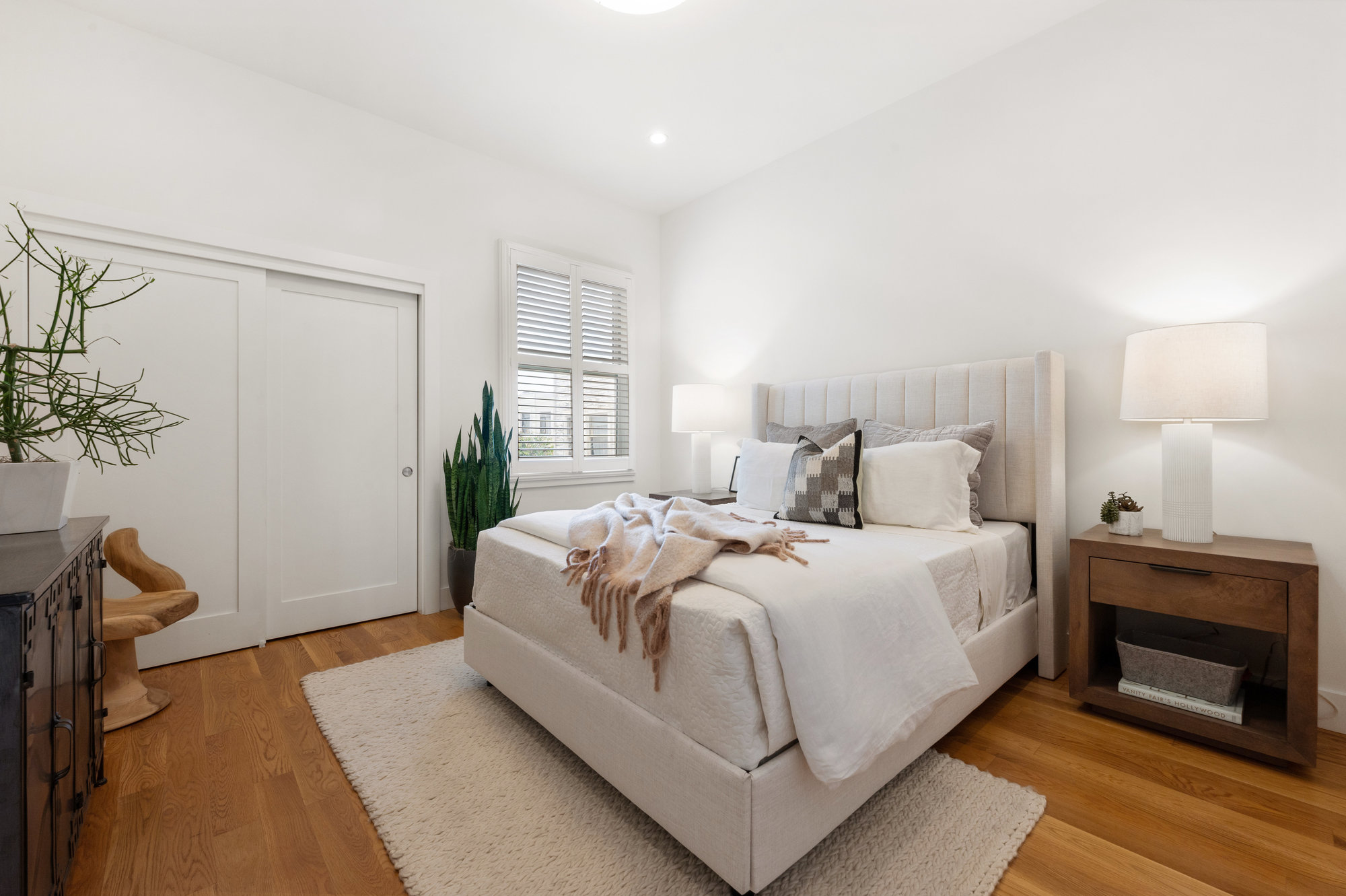 View of bedroom two, featuring a large window and closets