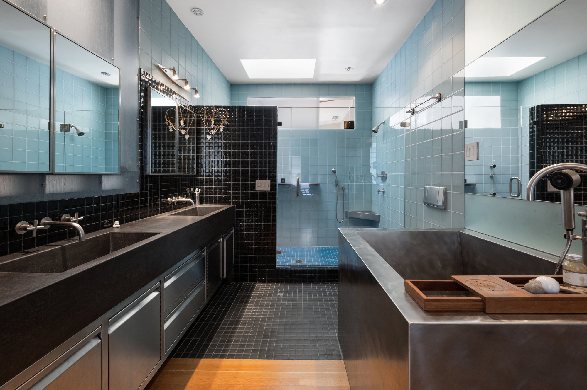 View of a large bathroom with soaking tub, double vanity, and glass shower