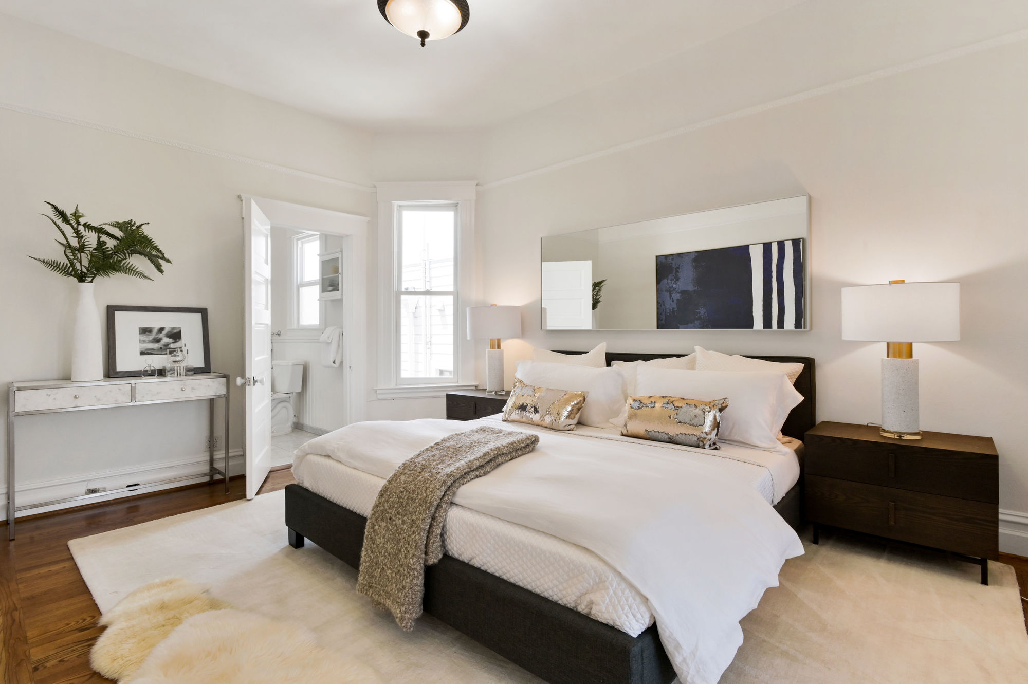 View of the primary bedroom, featuring wood floors