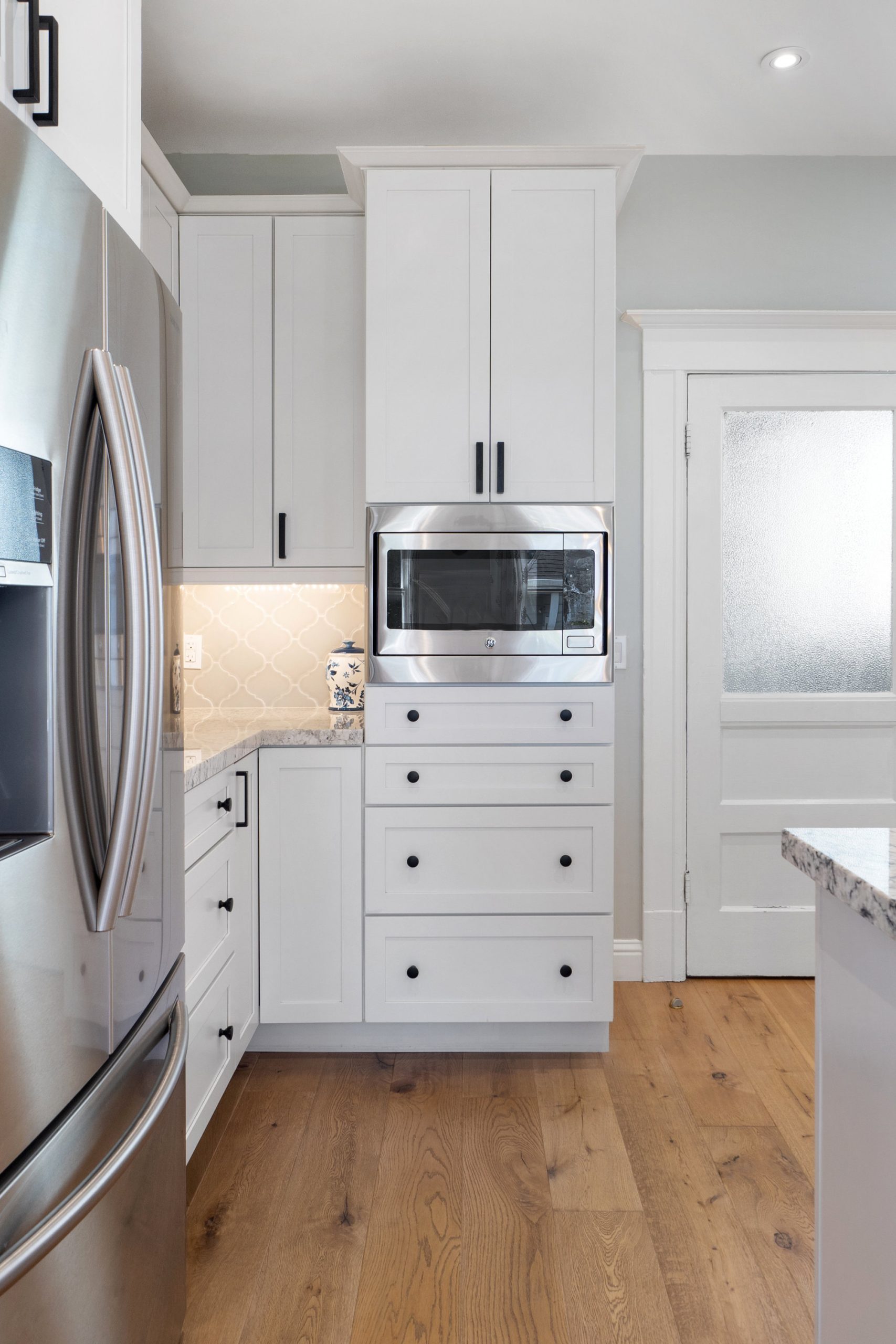 029030 Close-up view of the white wood cabinetry in the kitchen